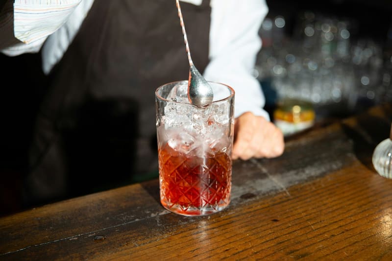 stirring a negroni in a cut glass