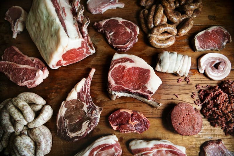 cuts of raw meat on a board