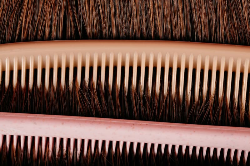 two combs against brown hair