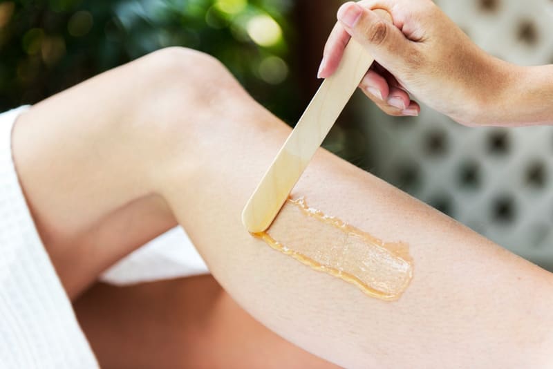warm wax spread on a leg