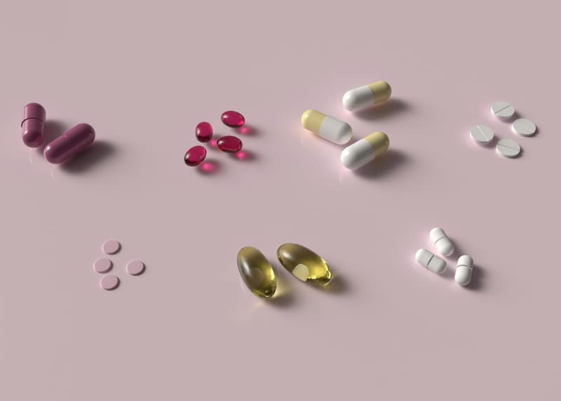 pills scattered on pink