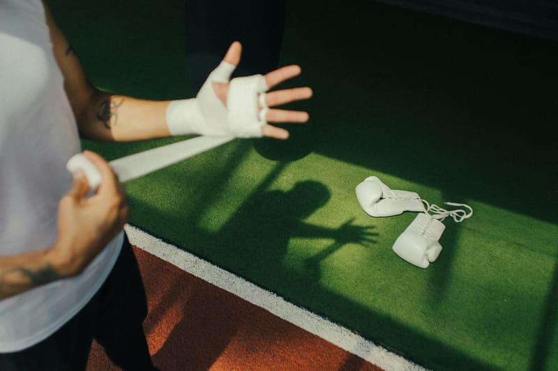 wrapped hands and boxing gloves on turf
