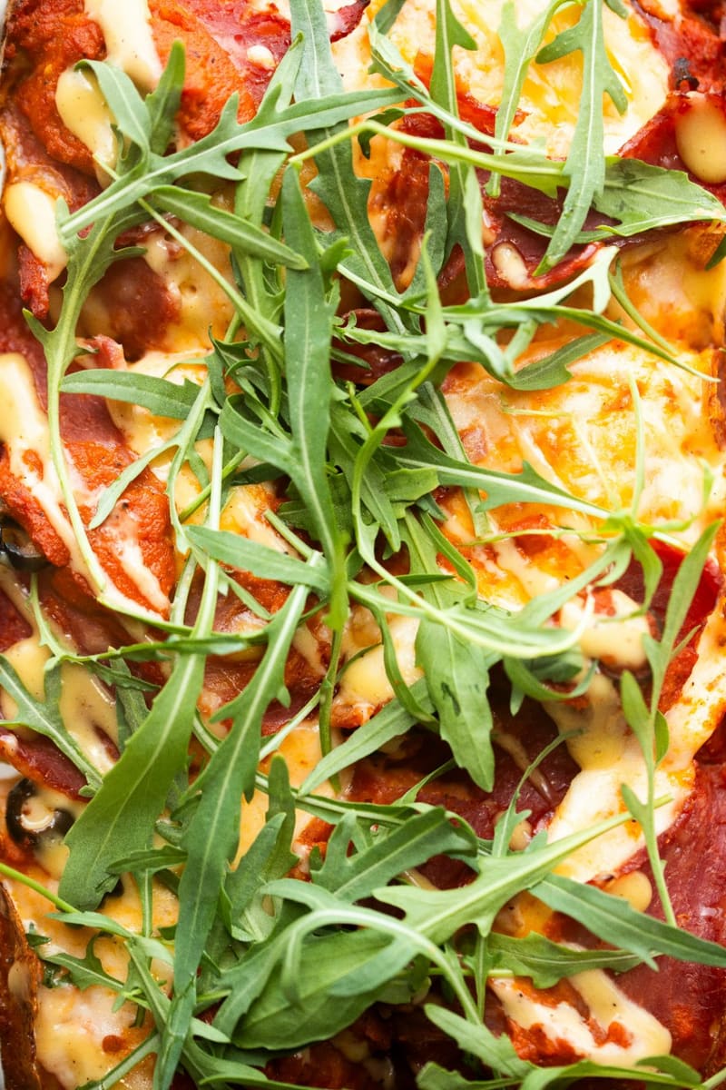 a pizza with rocket on top