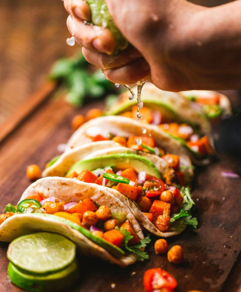 lime squeezed over three tacos