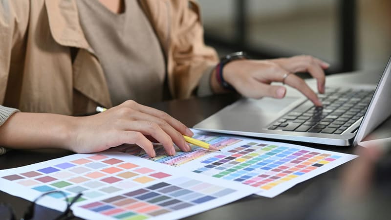 colour charts beside a laptop