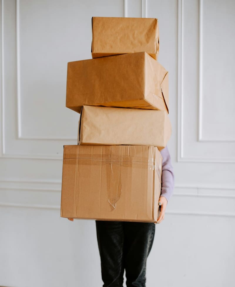 someone carrying a stack of boxes