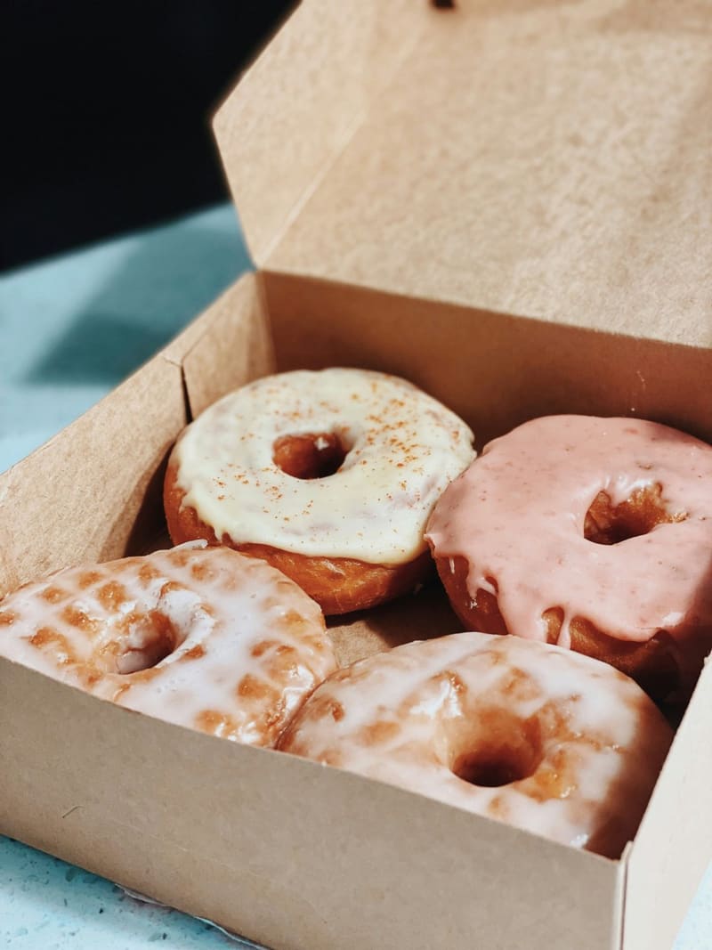 four glazed doughnuts in a box
