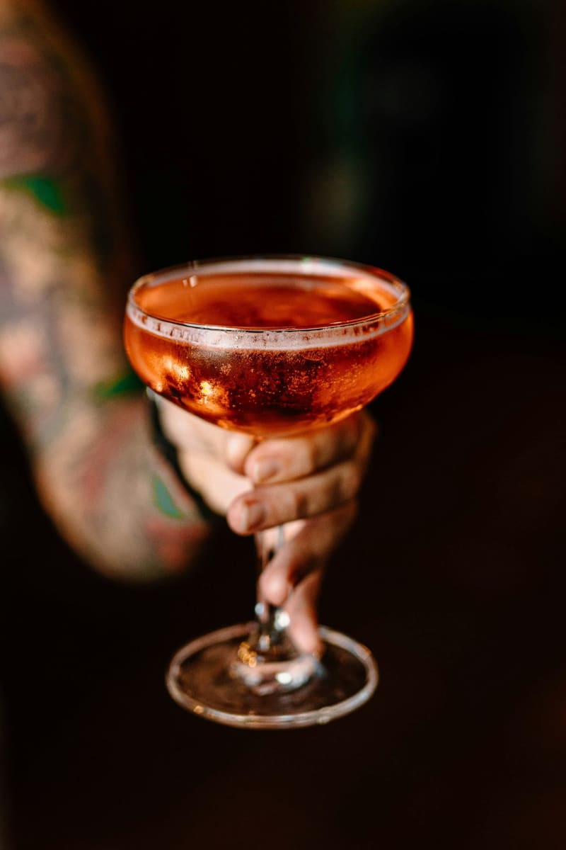 a coupe cocktail held up