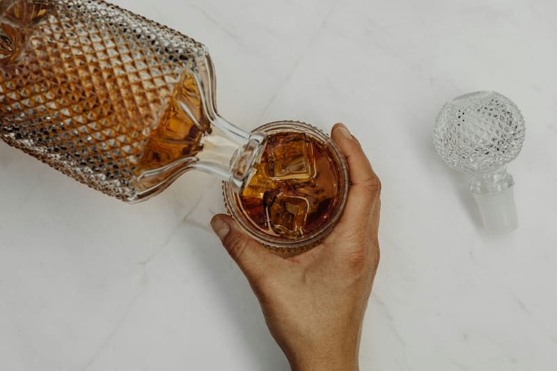 pouring whisky from a decanter