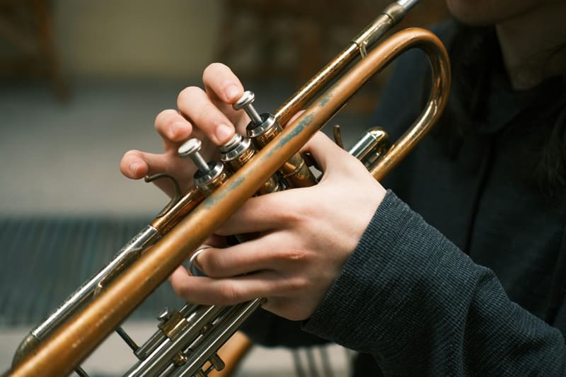 hands on a trumpet's valves