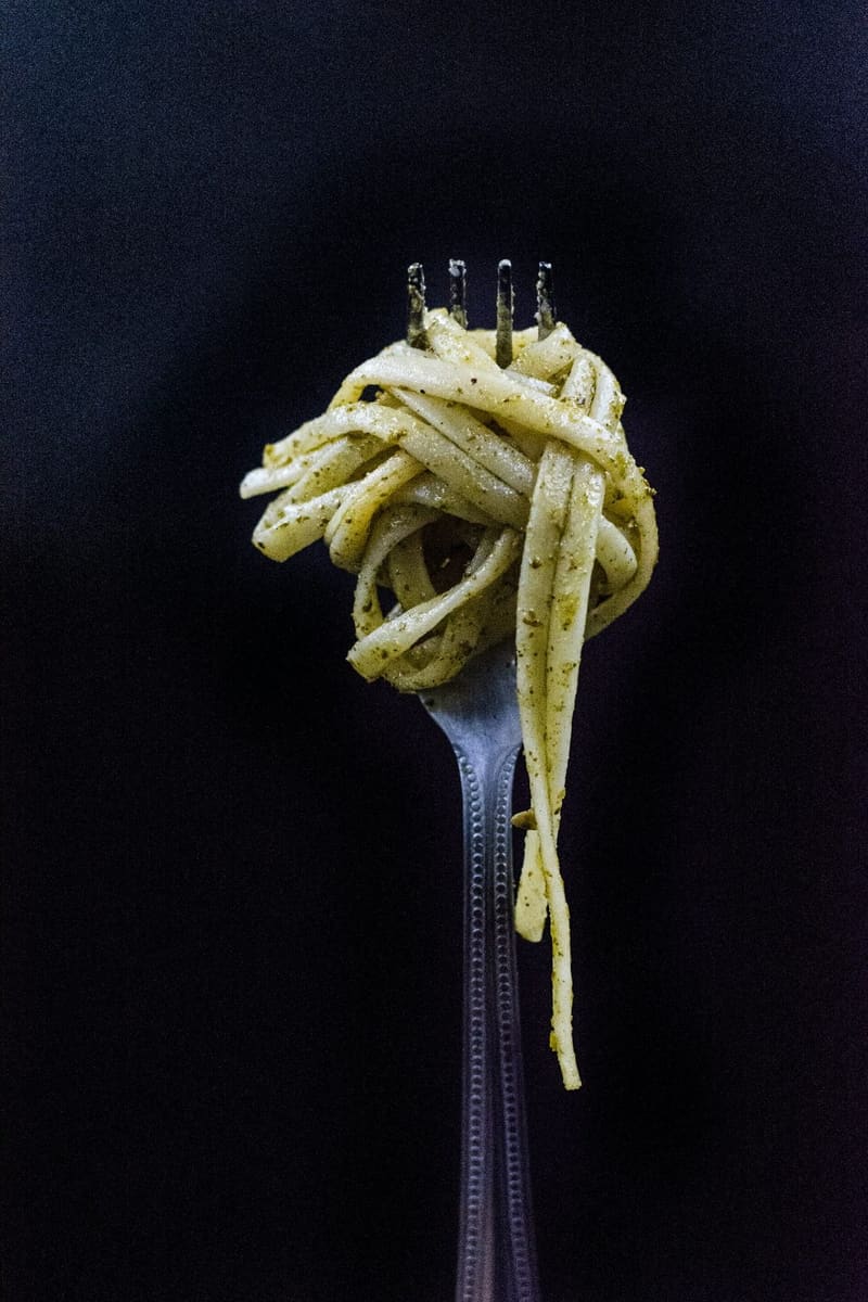 pesto linguine twirled on a fork