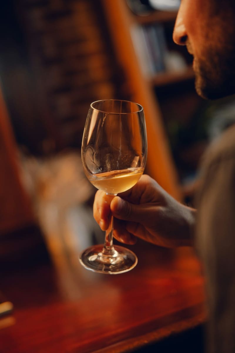 a glass of white wine at a bar
