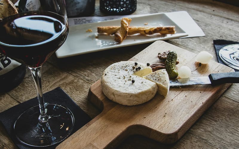 cheese and red wine on a board