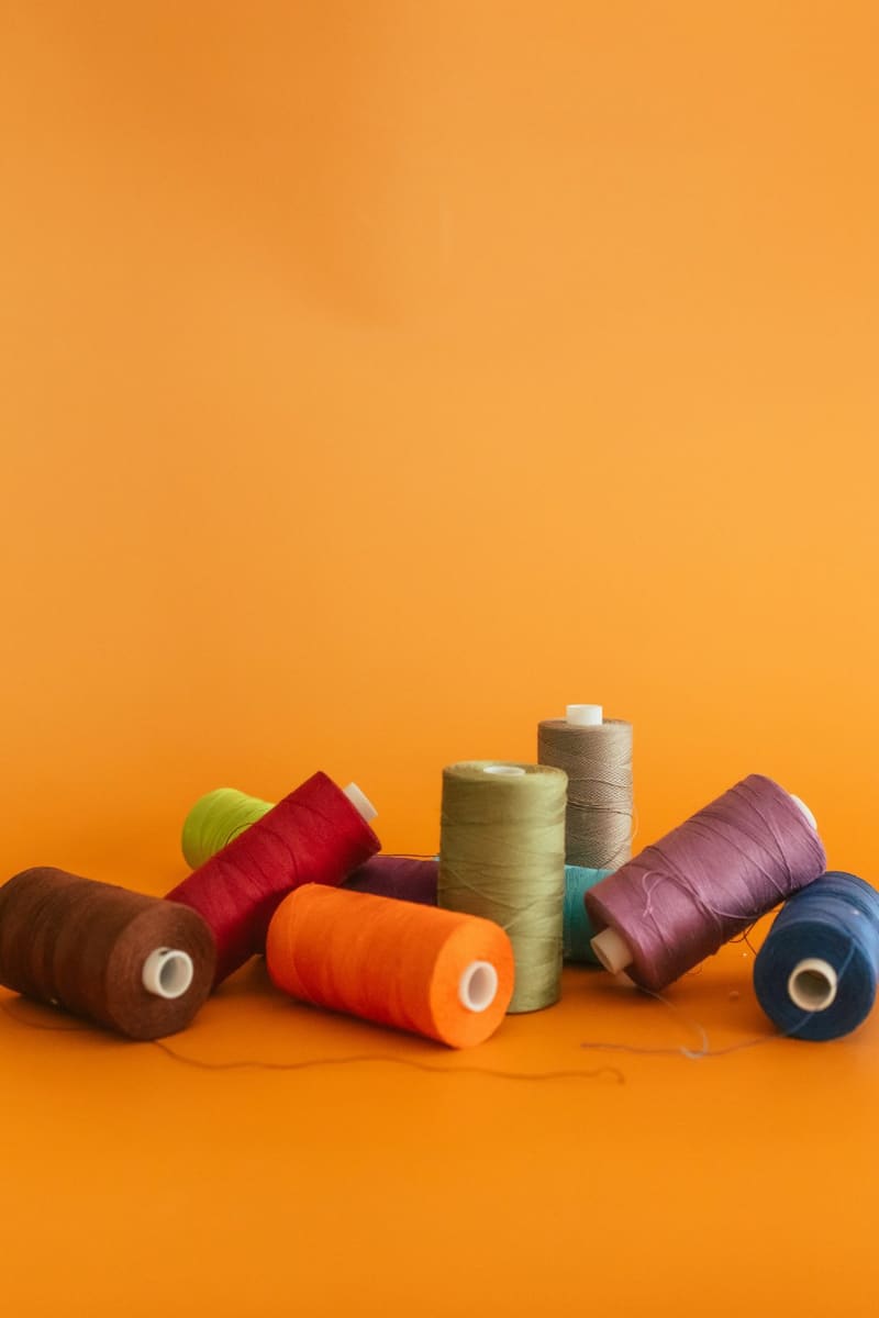 spools of coloured thread on orange