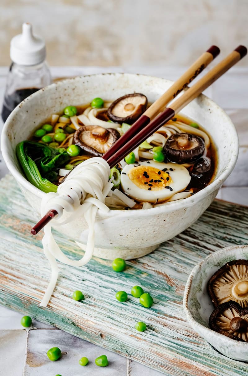 udon noodles lifted with chopsticks