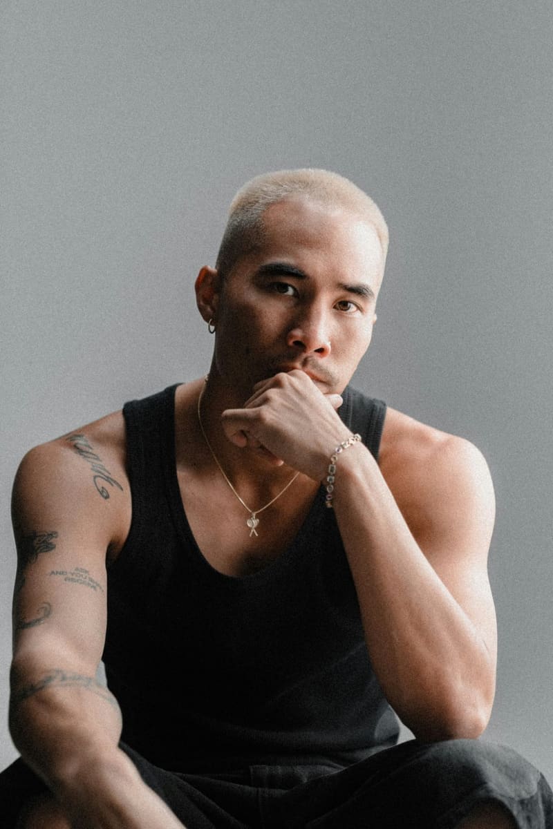 a tattooed man in a black vest