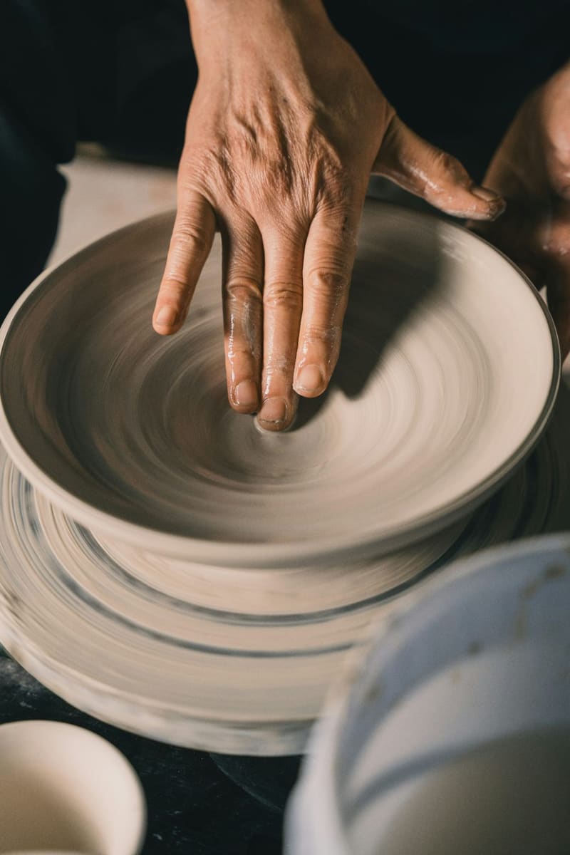 hands centring clay on a wheel