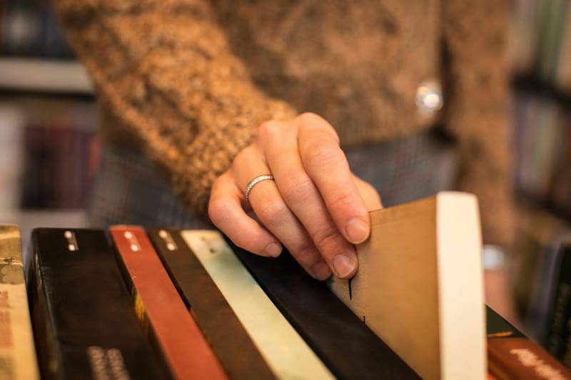 a hand smoothing leather on a bench