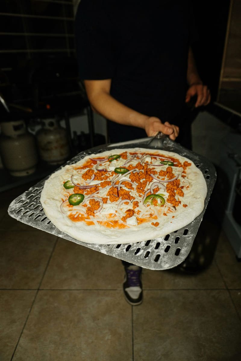 a pizza going on the peel