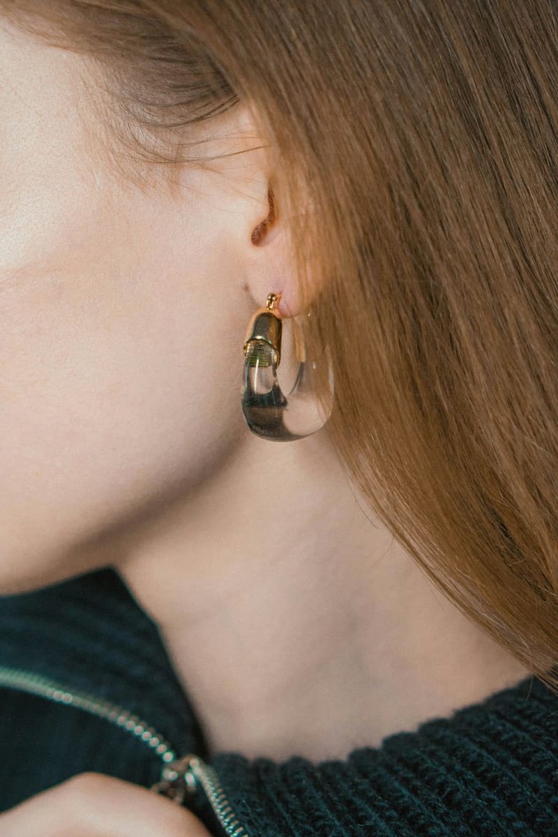 an amber hoop earring on an ear
