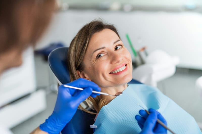 a smiling patient in a dental chair