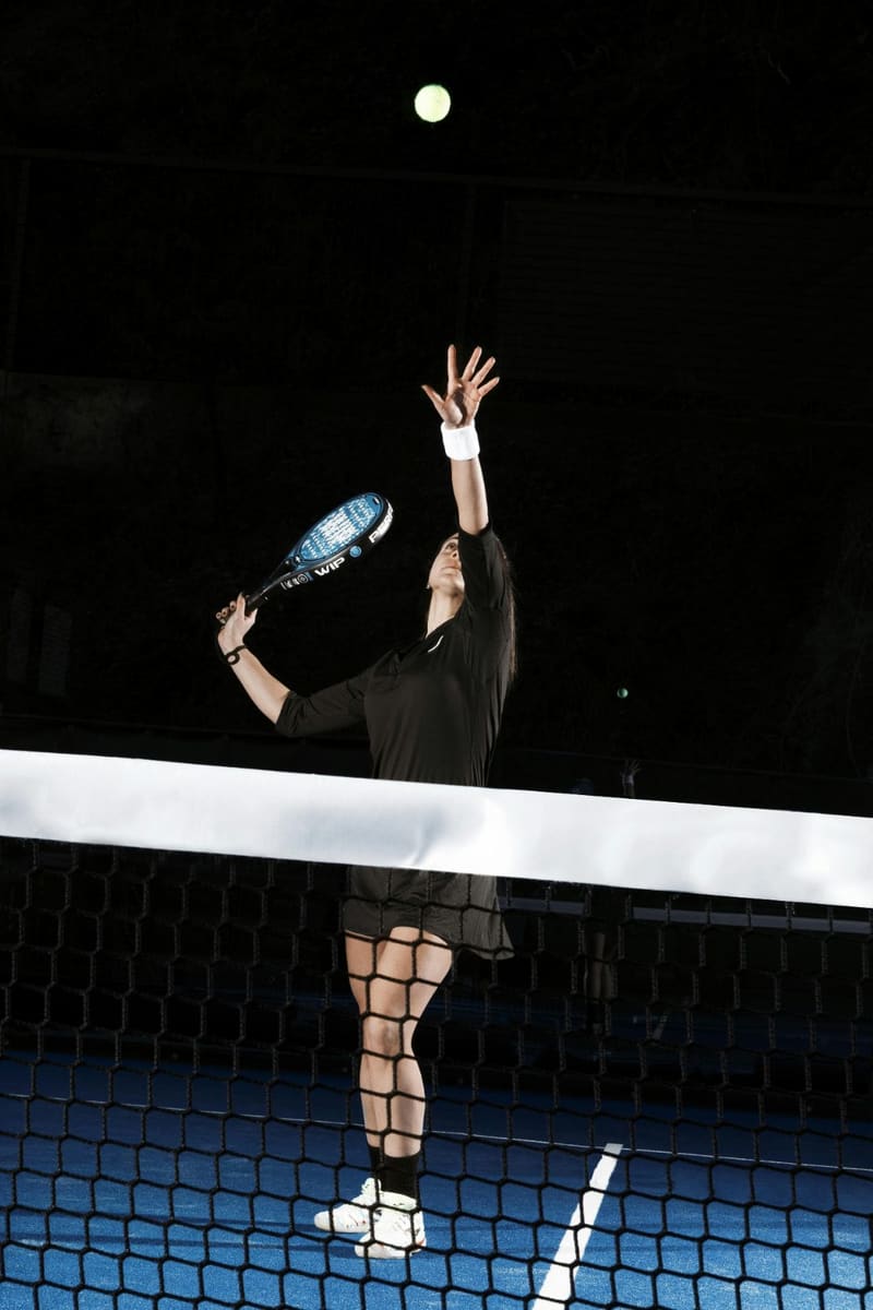 a serve on a floodlit court