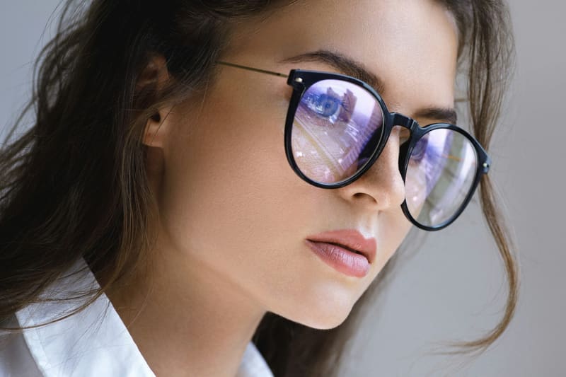 a woman wearing round spectacles