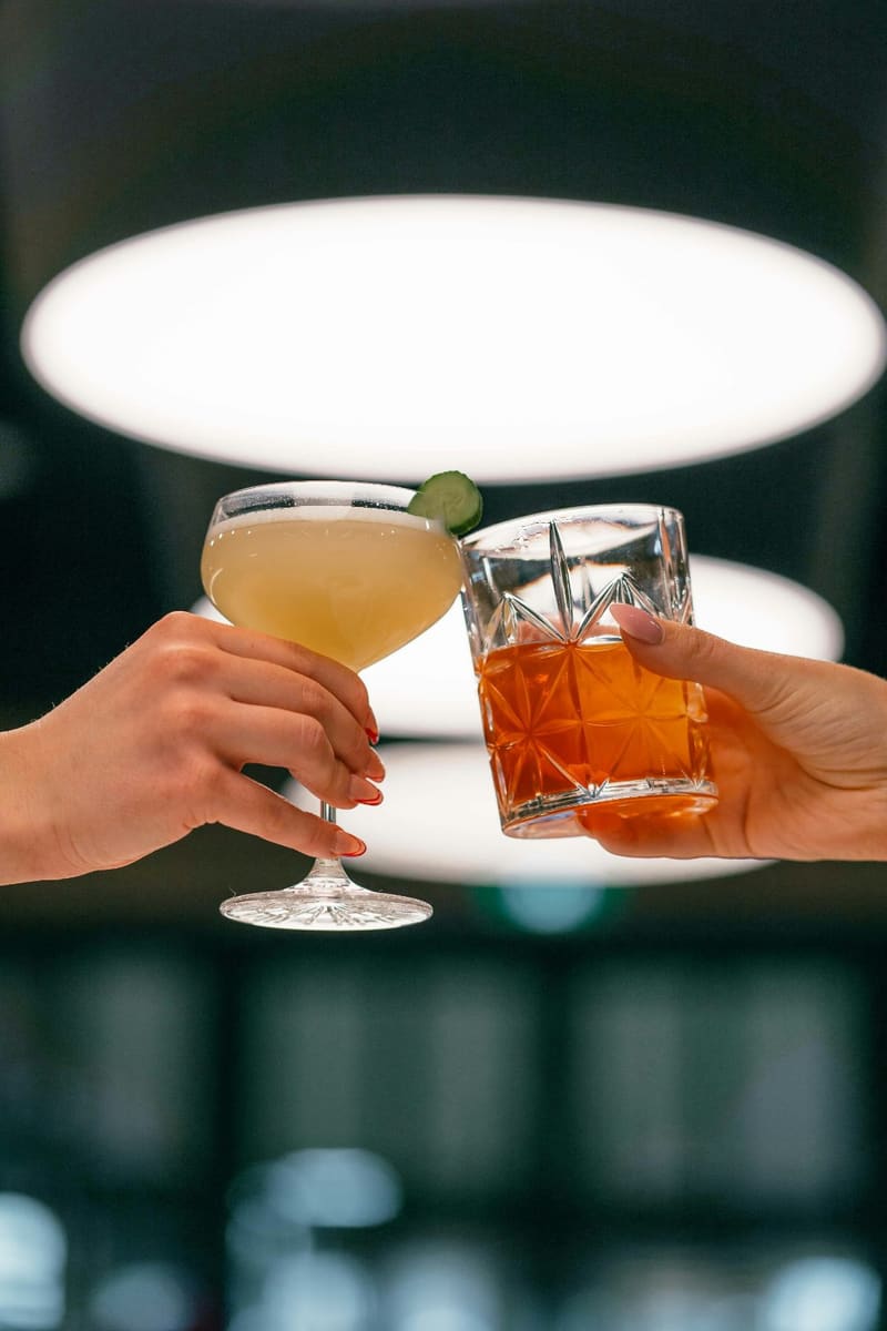 two cocktails toasting
