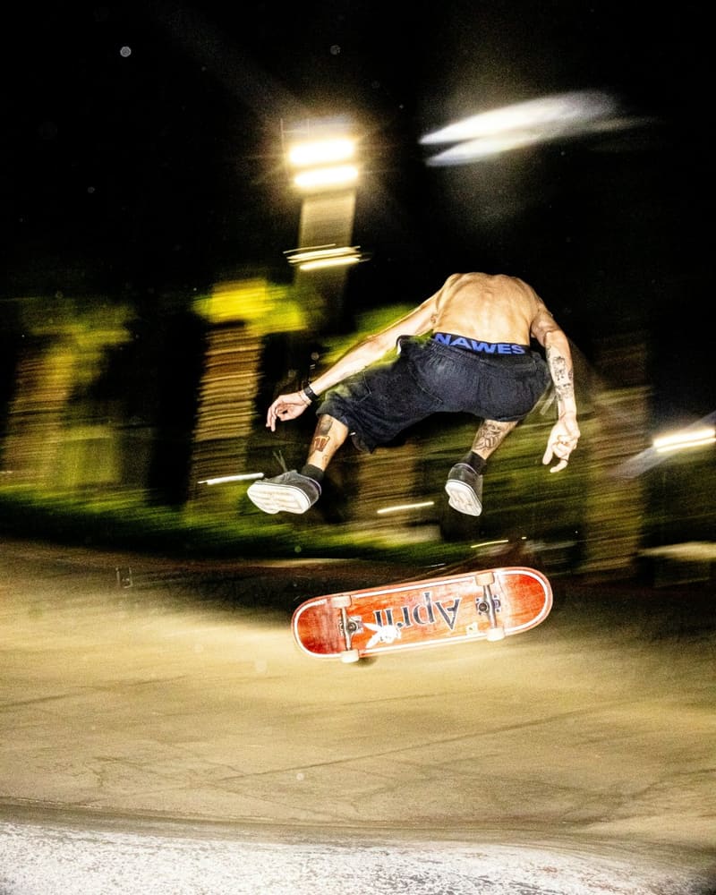 a skateboarder mid trick at night