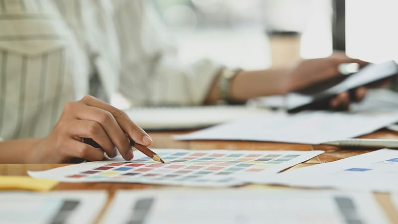 a hand over a colour chart