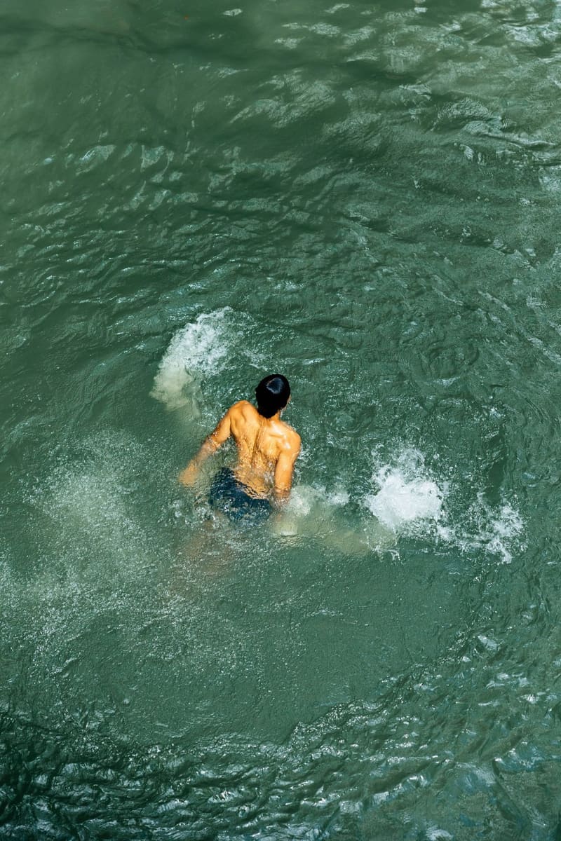 a swimmer in green water