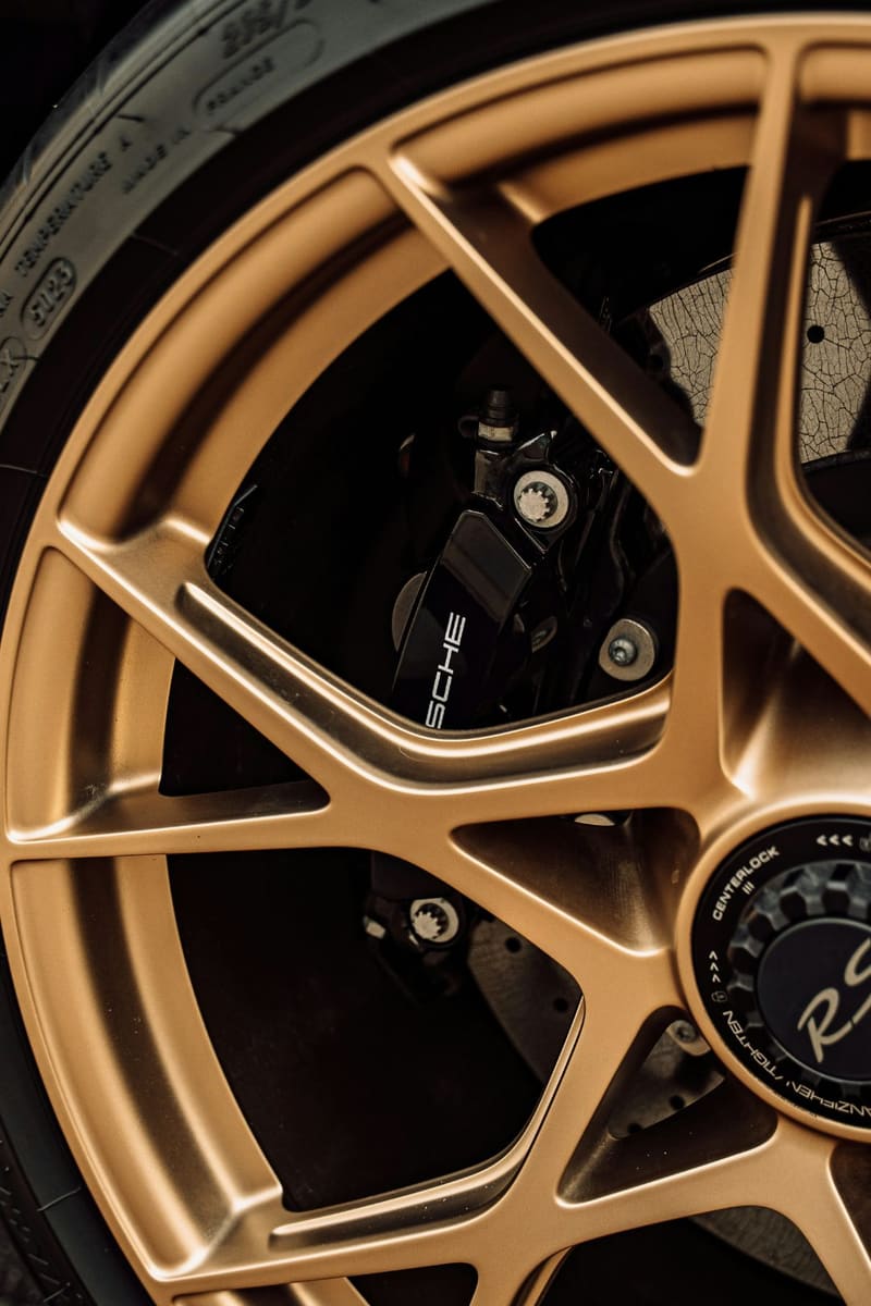 a gold alloy wheel and brake caliper