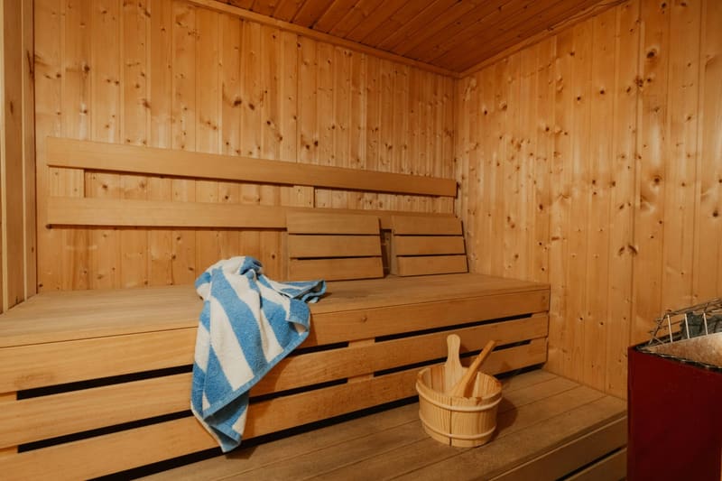 a pine sauna bench with a towel