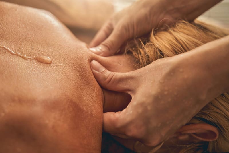 hands kneading a shoulder