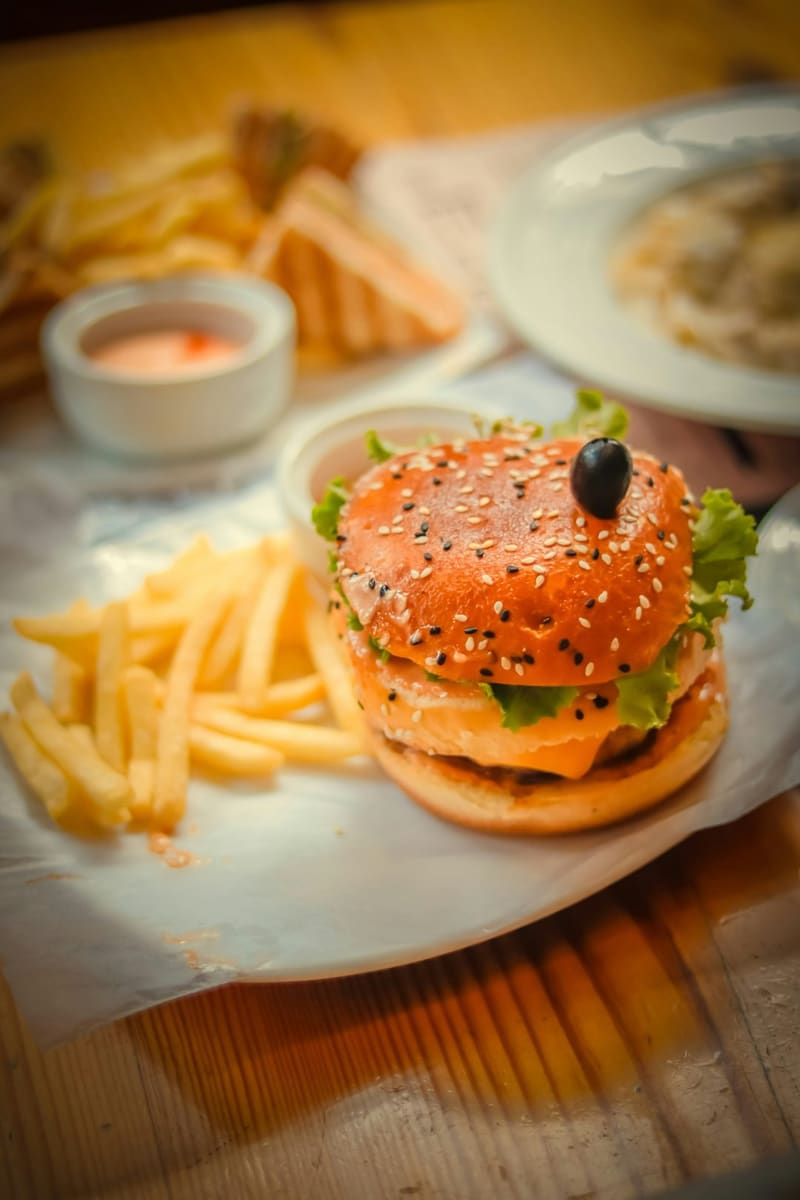 a burger with fries and dip