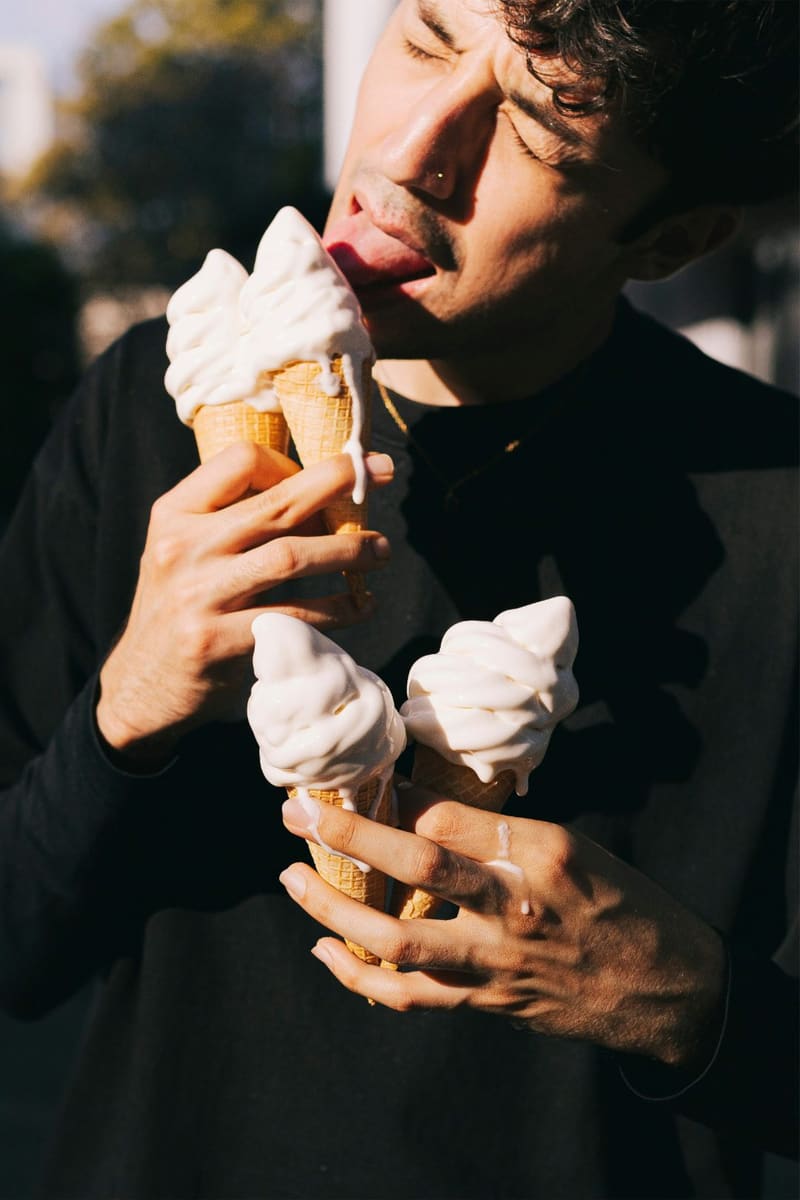 a man eating a soft serve cone