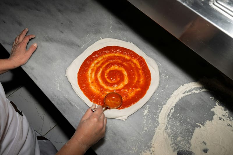 sauce spread on a pizza base