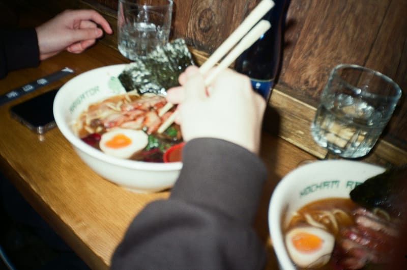 someone eating ramen with chopsticks