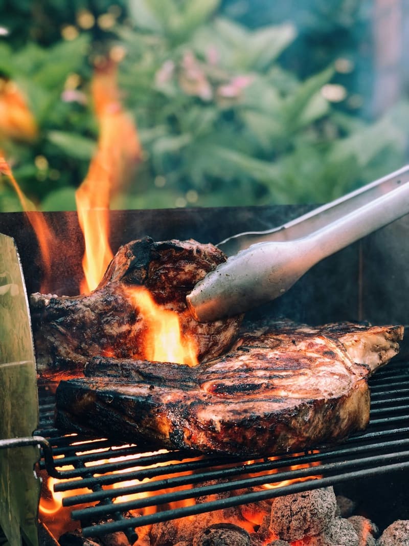 steaks over an open flame